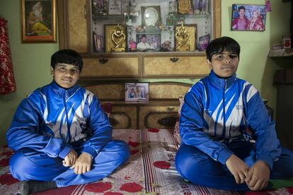 Geetanjali y Megha Luckad posan tras el entrenamiento en la cama que comparten en una pequeña vivienda de un barrio humilde de Delhi.