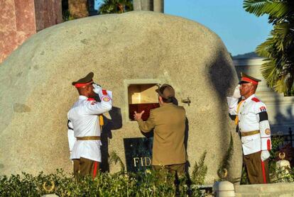 El presidente de Cuba, Raúl Castro (centro), coloca en la tumba la urna con las cenizas del líder cubano Fidel Castro en el cementerio Santa Ifigenia, en Santiago de Cuba.