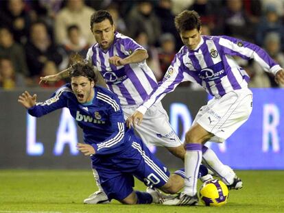 Higuaín cae acosado por Marcos y Vivar Dorado.