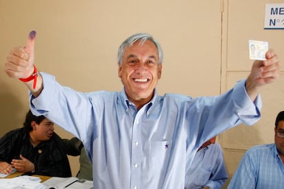 Sebasián Piñera muestra su carnet y su dedo entintado tras haber votado en los comicios en los que resultaría triunfador, en Santiago, el 13 de diciembre de 2009.
