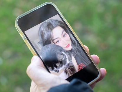 Daniel, a victim of a cyber scam, shows a photo of Adele, the fictional character with whom he was deceived.