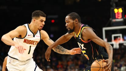 Kevin Durant (35) moves the ball against Denver Nuggets forward Michael Porter Jr. (1) in the first half at Footprint Center.