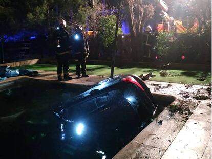 Los bomberos, durante el rescate del turismo siniestrado.