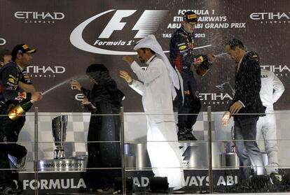 Webber y Vettel celebran la victoria en el podio de Yas marina.