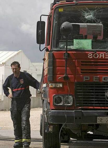 Un bombero, junto al camión apedreado por varios vecinos.