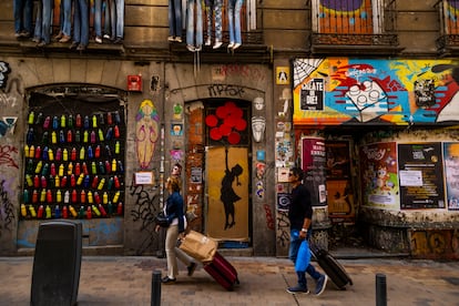 Dos turistas arrastran sus maletas por un barrio del centro de Madrid, el jueves. 
