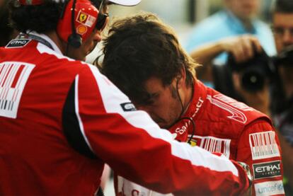 Fernando Alonso, with one of the Ferrari team, after losing out on his third world title in Abu Dhabi.