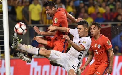 Isla, Torres y Vargas luchan por el balón.