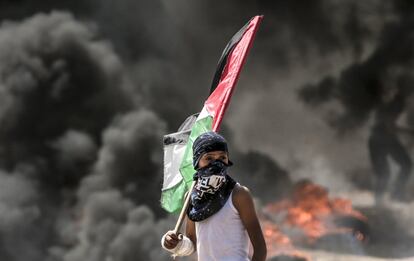 Un niño sujeta la bandera de Palestina durante los enfrentamientos en la franja de Gaza, el 14 de mayo de 2018.