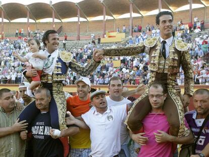 Los toreros &#039;Morenito de Aranda&#039; (derecha) y David Mora salen por la puerta grande de la plaza de toros de Burgos.