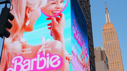 A huge digital promotional poster featuring Margot Robbie as 'Barbie' in New York. 