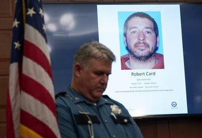 A police officer stands next to a screen displaying the picture of the suspected shooter, during a press conference following the deadly mass shooting, at City Hall in Lewiston, Maine, U.S. October 27, 2023.
