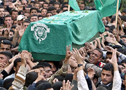 Una multitud acompaña al féretro, cubierto con la bandera verde de Hamás, con los restos mortales de Ahmed Yassin.