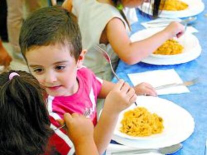 Un grupo de niños en un comedor escolar.