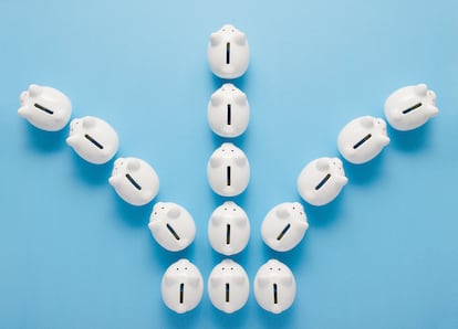 3 lines of 5 little white piggy banks, one going left, middle one going straight, another going left, view from above