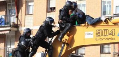Police clash with residents trying to stop a home eviction in Madrid in February.