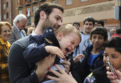 Mata sostiene a un niño durante el acto de homenaje de Oviedo.