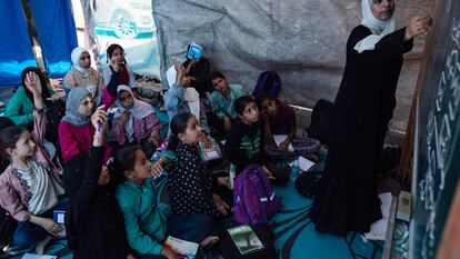 Palestinian students attend a class at a tent school in the Khan Yunis refugee camp in the southern Gaza Strip on June 13.