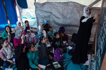 Palestinian students attend a class at a tent school in the Khan Yunis refugee camp in the southern Gaza Strip on June 13.