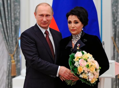 Russian President Vladimir Putin presents a medal to Head of the Russian Rhythmic Gymnastics Federation Irina Viner, in the Kremlin in Moscow, Russia, on May 1, 2015.