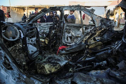 Varios niños observan los restos de un coche tras un ataque israelí, este lunes en Jan Yunis, en el sur de Gaza.