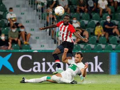 Iñaki Williams remata defendido por Gonzalo Verdú,  durante el Elche-Athletic de LaLiga disputado este lunes en el estadio Martínez Valero. EFE / Manuel Lorenzo