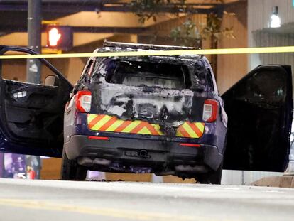 A burned police car sits on the street following a violent protest, Saturday, Jan. 21, 2023, in Atlanta, in the wake of the death of an environmental activist killed after authorities said the 26-year-old shot a state trooper.