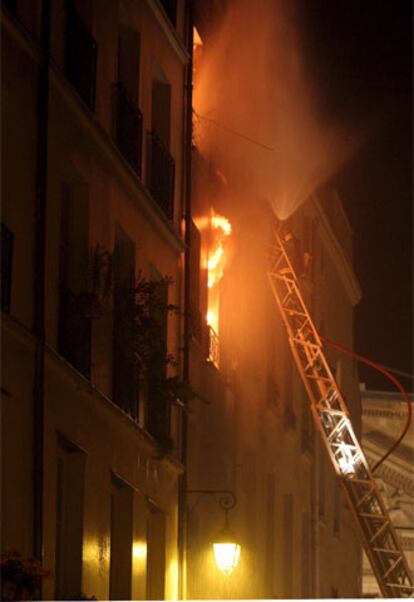 Los bomberos intentan apagar las llamas en el edificio siniestrado del centro de París.