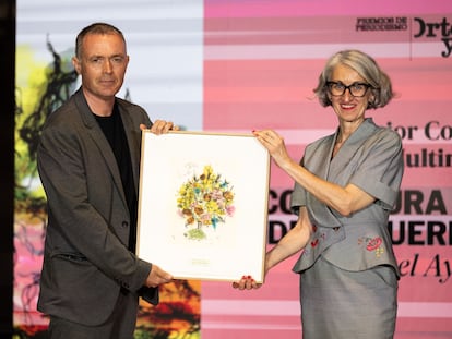 Mikel Ayestarán, premio a la mejor cobertura multimedia, recibe el galardón de manos de Soledad Alcaide, defensora del lector del diario El País.