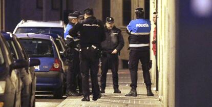 Agentes de la Policía Municipal y de la Policía Nacional, en el acceso a la vivienda donde resultó herida la mujer.