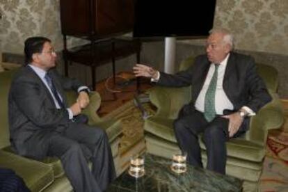 El ministro de Asuntos Exteriores, José Manuel García-Margallo (d), conversa con el secretario de la Organización Mundial del Turismo (OMT), Taleb Rifai, durante la reunión que ambos han mantenido hoy en Madrid.