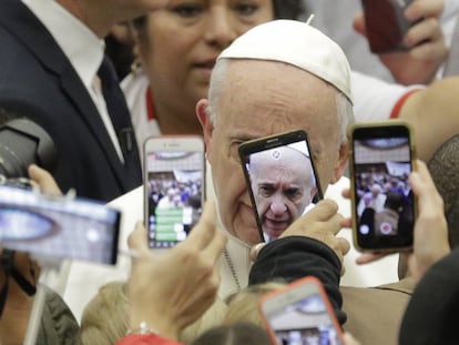 El papa Francisco es recibido por los móviles de la multitud en su llegada a la audiencia general semanal en la Ciudad del Vaticano, el 9 de enero de 2019.