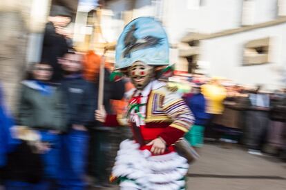 Un peliqueiro pasa por la plaza de A Picota antes de la puesta de sol que dará paso a la salida de la morena en el carnaval de Laza, el 12 de febrero de 2018.