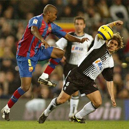 Samuel Eto&#39;o salta por el balón ante Alberto Rivera del Levante.