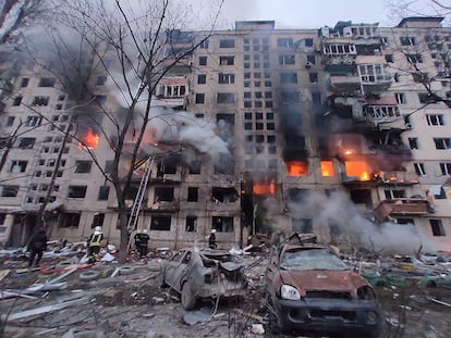 Fireighters work to extinguish a fire in an apartment building hit by shelling in the Obolon district of Kyiv. 