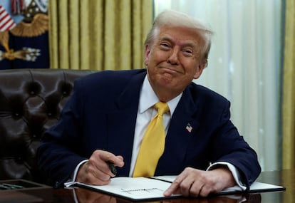 Donald Trump signs an executive order on March 7 in the Oval Office.