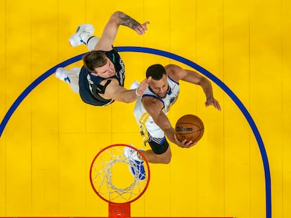 Steph Curry attacks the basket in front of Luka Doncic in Game 2 of the series between Dallas and Golden State.