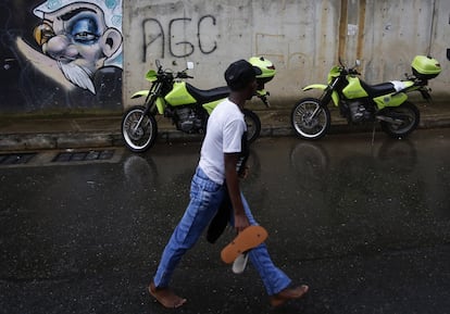 Un niño camina frente a motos de la Policía en el barrio La Sierra, en Medellín, en mayo del 2022.