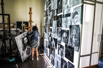 The Prado Museum’s senior lab technician Laura Alba moves an image produced using infrared reflectography of the painting ‘Christ between the Virgin Mary and Saint John the Baptist.’ On the right, a large, upright light table faces the entrance to the lab.
