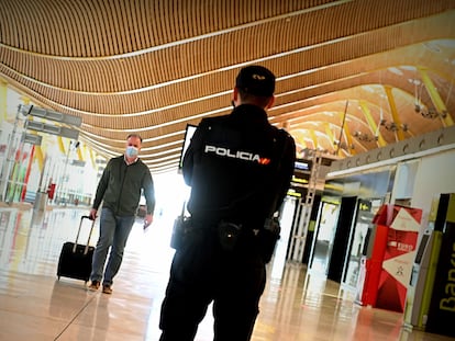 A police officer controls access to Terminal 4 at the Adolfo Suárez Madrid-Barajas airport after a state of alarm was declared in the region.