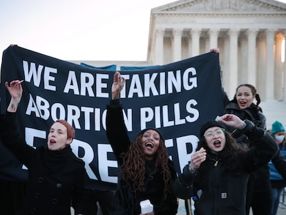 Un grupo de mujeres muestra la píldora abortiva en señal de apoyo al aborto libre frente a la sede del Tribunal Supremo, en Washington (EEUU), en diciembre de 2021.