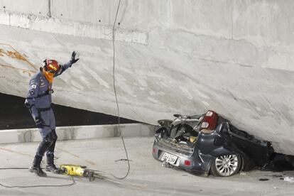 O carro preso na estrutura do viaduto.