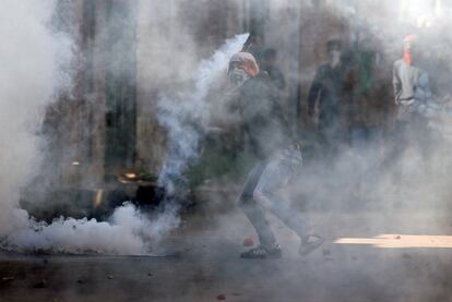 Un manifestante arroja un bote de gas lacrimógeno disparado por la policía india durante una protesta contra los recientes asesinatos en Cachemira, en Srinagar.

