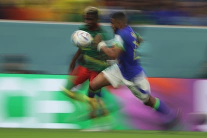 Brazilian soccer player Gleison Bremer and Cameroonian Ngom Mbekeli chase down a ball, during a match from the World Cup in Qatar, in December of 2022.