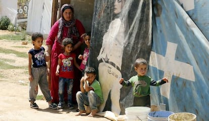 Una mujer y varios niños sirios del campo de refugiados libanés de Saadnayel.