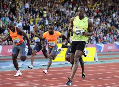 Usain Bolt, de amarillo, celebra su victoria en Londres.