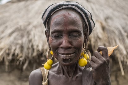 Una anciana bodi de la aldea del Parque Nacional de Mago posa con los ojos cerrados ('Kabarek Mudda' en su lengua) con el tradicional adorno bodi del labio inferior y el aderezo de unos frutos silvestres como complemento inusual de los originales pendientes de cobre realizados con las vainas de la munición del AK-47. Algunas tribus han comenzado a representar decoraciones corporales y adornos más comunes entre las tribus más inaccesibles.