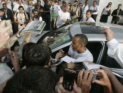 Lewis Hamilton firma autógrafos a la salida del circuito de Melbourne.