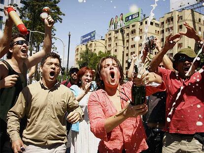 Manifestantes anti-Pinochet gritan y descorchan bolletas de champán ayer en las calles de Santiago de Chile.