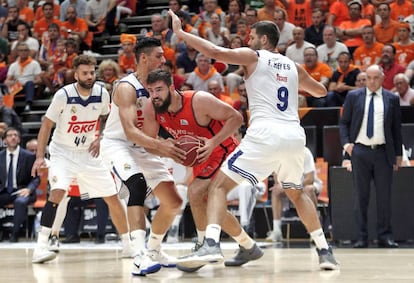 El pivot montenegrino del Valencia Basket, Bojan Dubljevic (2d), trata de superar la defensa de los pivots del Real Madrid, Felipe Reyes y el mexicano Gustavo Alfonso Ayón, durante la disputa del cuarto partido de la final de la Liga ACB.